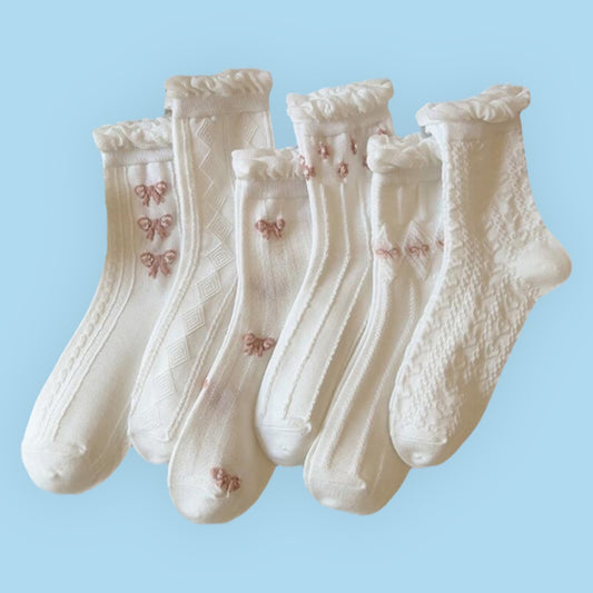 5 pairs of women’s mid-tube socks in a light, breathable white lace design with a charming bow accent